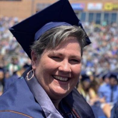 Ortiz smiling in her graduation regalia.